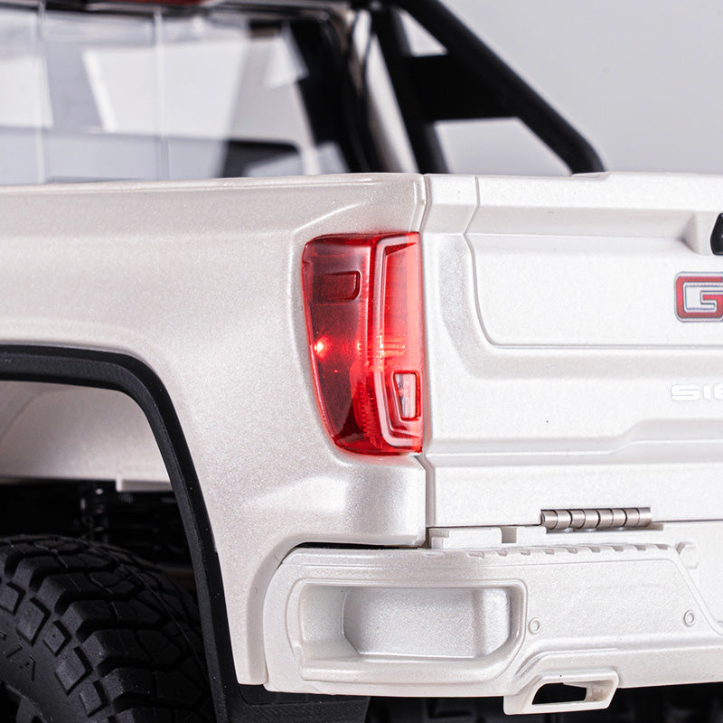 1:18 GMC Sierra S RTR brushless RC truck, white, showing rear taillight, GMC logo, and tire tread.