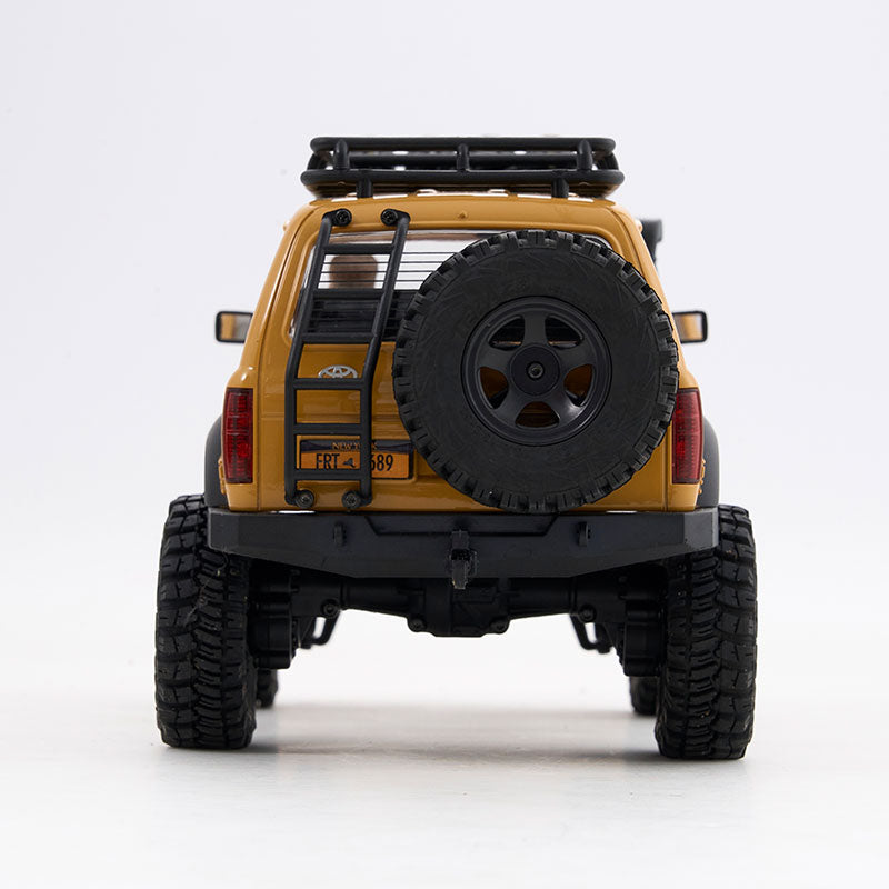 Yellow FMS 1:18 LC80 Toyota Land Cruiser with spare tire, roof rack, and ladder.