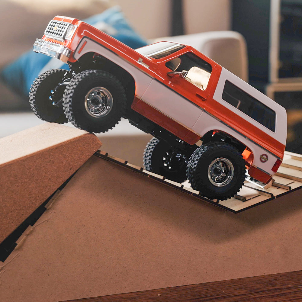 FMS 1:24 FCX24 Chevrolet K5 Blazer RTR RC truck climbing a ramp