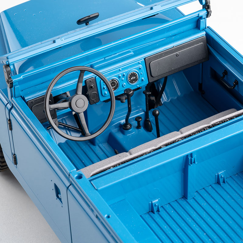 FMS 1:12 Land Rover Series II RTR blue interior, steering wheel, dashboard with gauges, gear shifter, and seats.