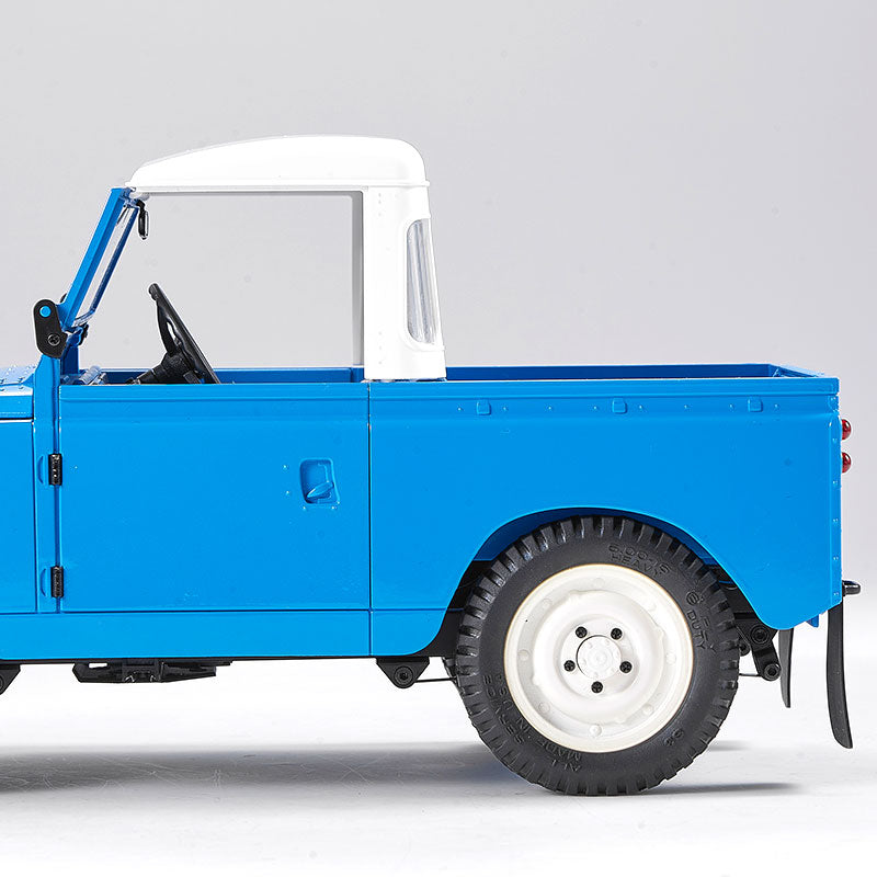 Blue FMS 1:12 Land Rover Series II RTR model with white roof and interior details.