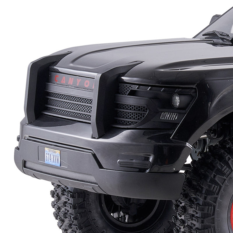 FMS 1:10 Canyon RS front grille with red CANYON lettering and black honeycomb detail. Nevada license plate '674-XYM'.