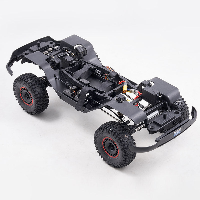 FMS 1:10 Canyon RS chassis with black rugged tires, visible suspension, steering servo, and motor components.