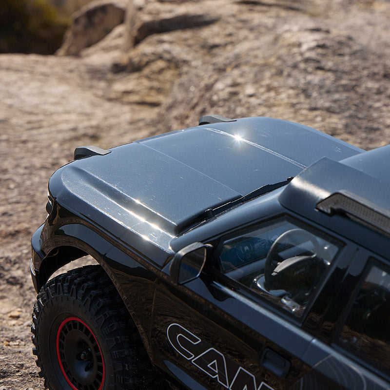 FMS 1:10 Canyon RS RC truck hood detail, gloss black finish with subtle reflections.