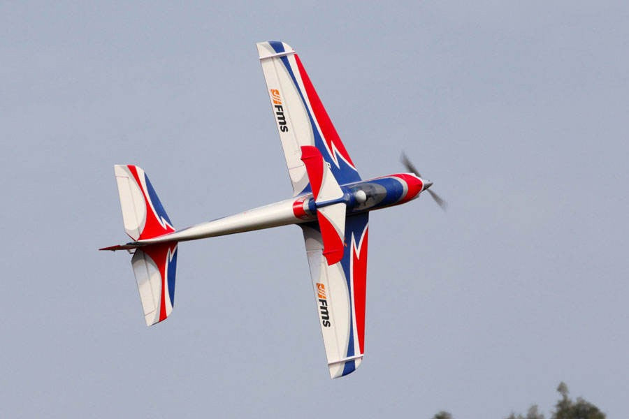 FMS 1400mm F3A Olympus PNP aerobatic RC airplane in flight, white with red and blue graphics.