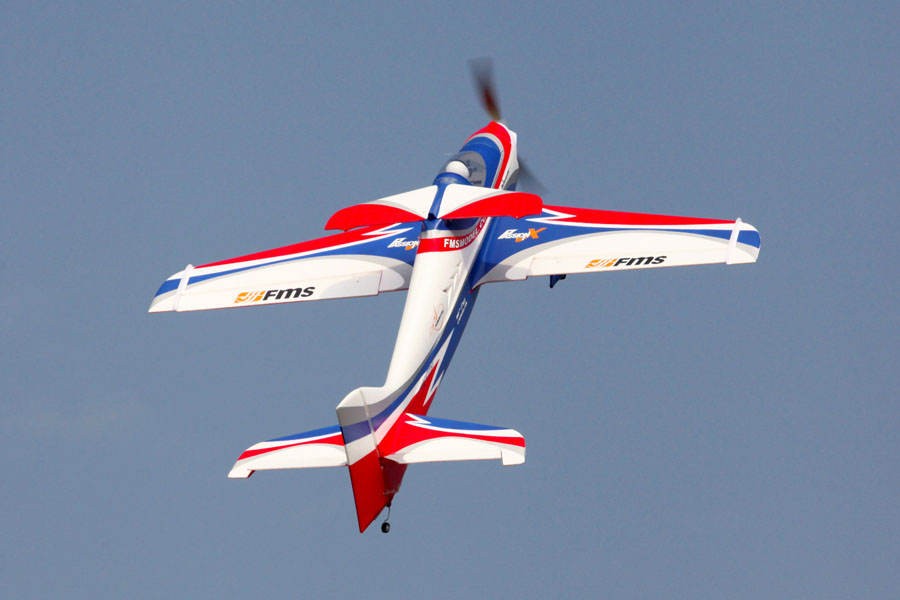 FMS 1400mm F3A Olympus PNP aerobatic RC airplane in flight with red, white, and blue design.