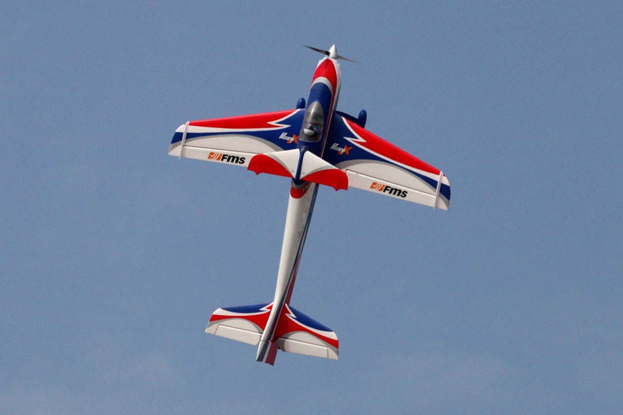 FMS 1400mm F3A Olympus PNP aerobatic RC plane with red, white, and blue graphics in flight.