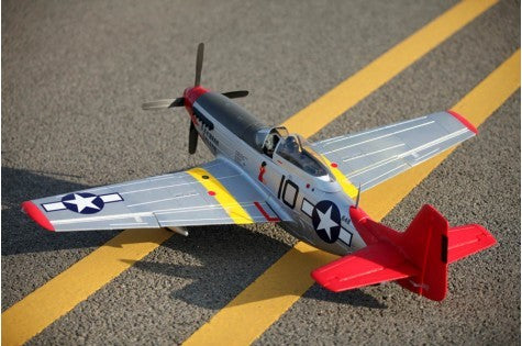 FMS 1450mm P-51D Red Tail V8 PNP RC airplane on tarmac with yellow markings, featuring scale detailing and red tail fin.