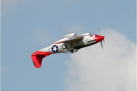 FMS 1450mm P-51D Red Tail V8 PNP RC airplane in flight, silver fuselage with red accents and US star insignia.