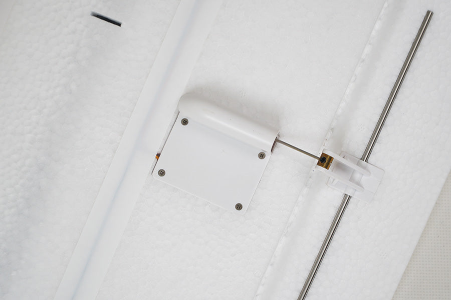 Close-up of FMS 2500mm ASW-17 EP Glider control linkage with white servo cover and silver rod.