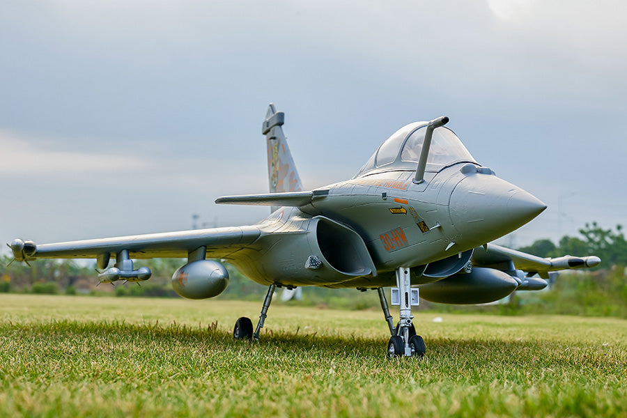 FMS 64mm Rafale PNP RC jet with gray camouflage livery and orange markings '30-HW' on a grassy field.
