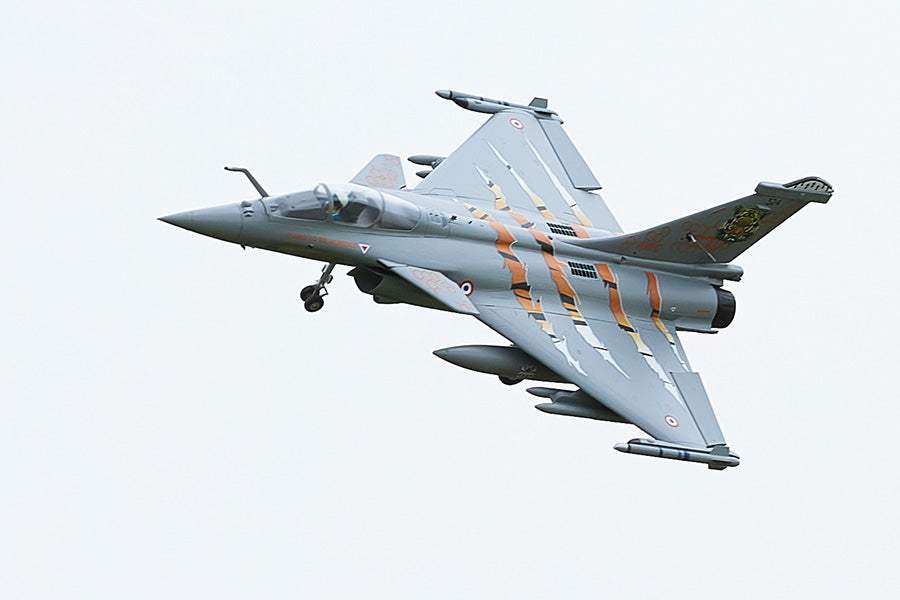 FMS 64mm Rafale jet, NATO Tiger Meet livery, flying with landing gear down. Orange tiger stripes.