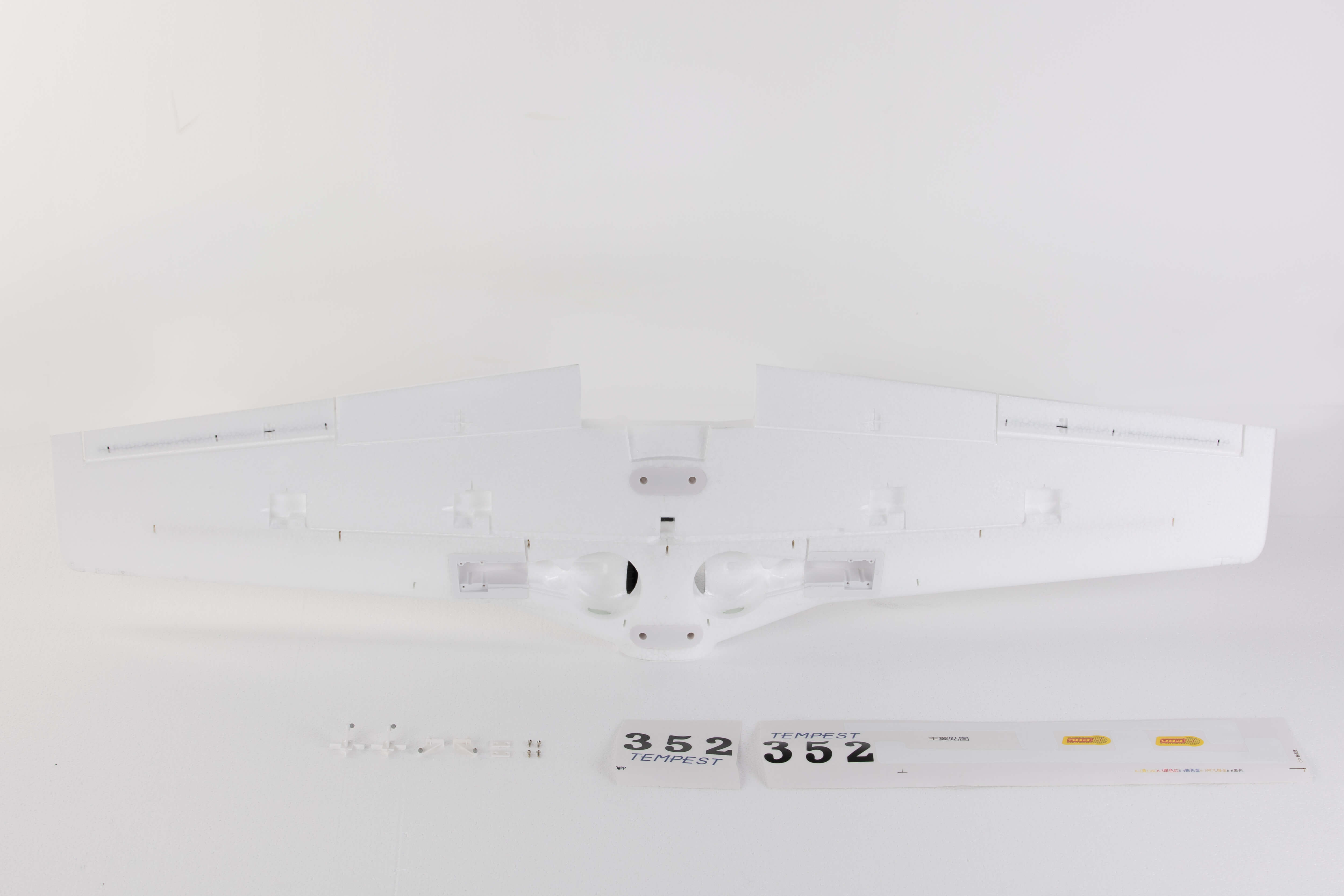 Underside view of 1100mm P-51 main wing in white with decals and assembly accessories