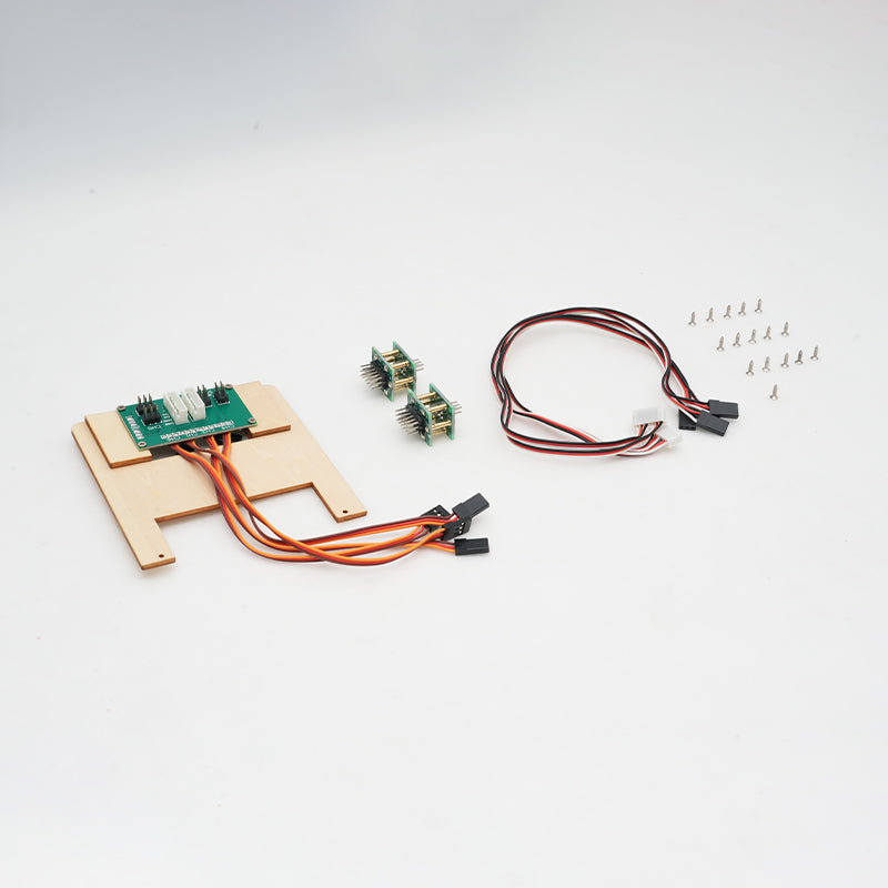 RC electronic components kit including a circuit board, wiring harnesses, connectors, and screws, neatly arranged on a white background.