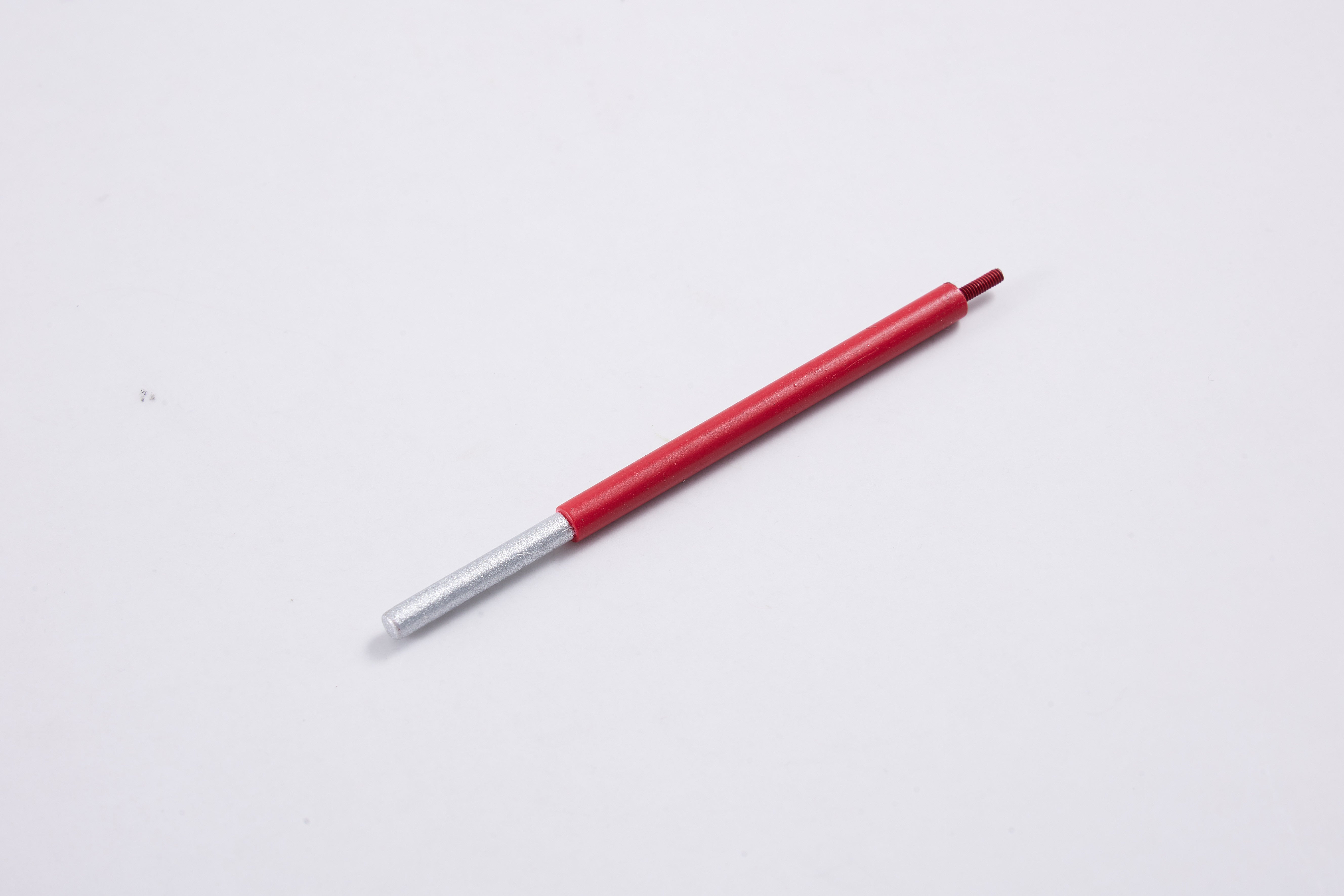 Red pen with silver tip on a plain white background