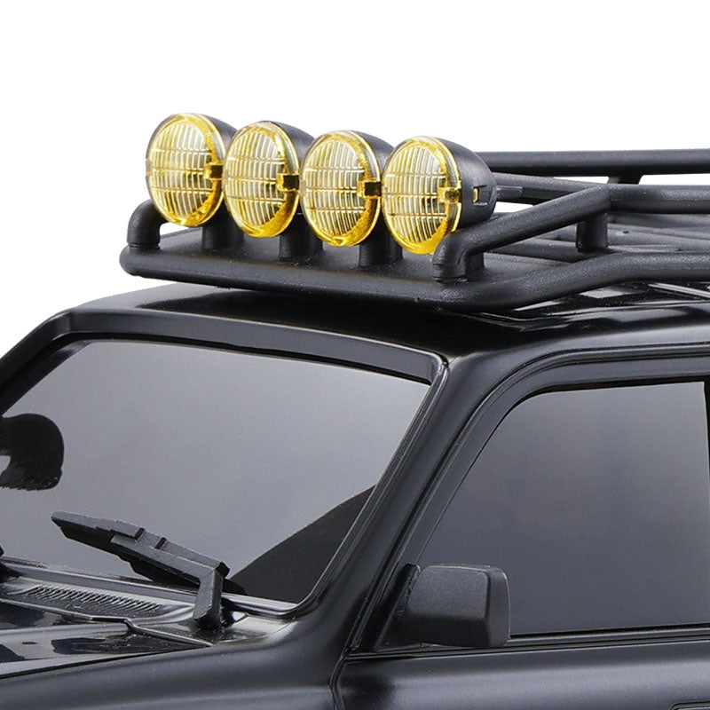 FMS 1:18 LC80 Toyota Land Cruiser 80 with four yellow auxiliary lights on a black roof rack.