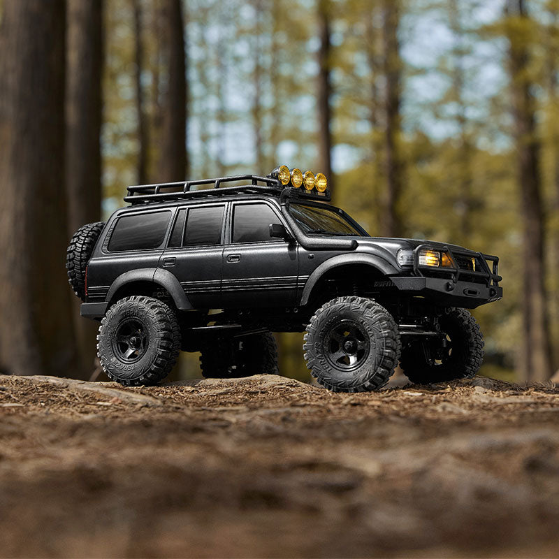 FMS 1:18 scale black Toyota Land Cruiser 80 RC crawler with roof rack and off-road tires