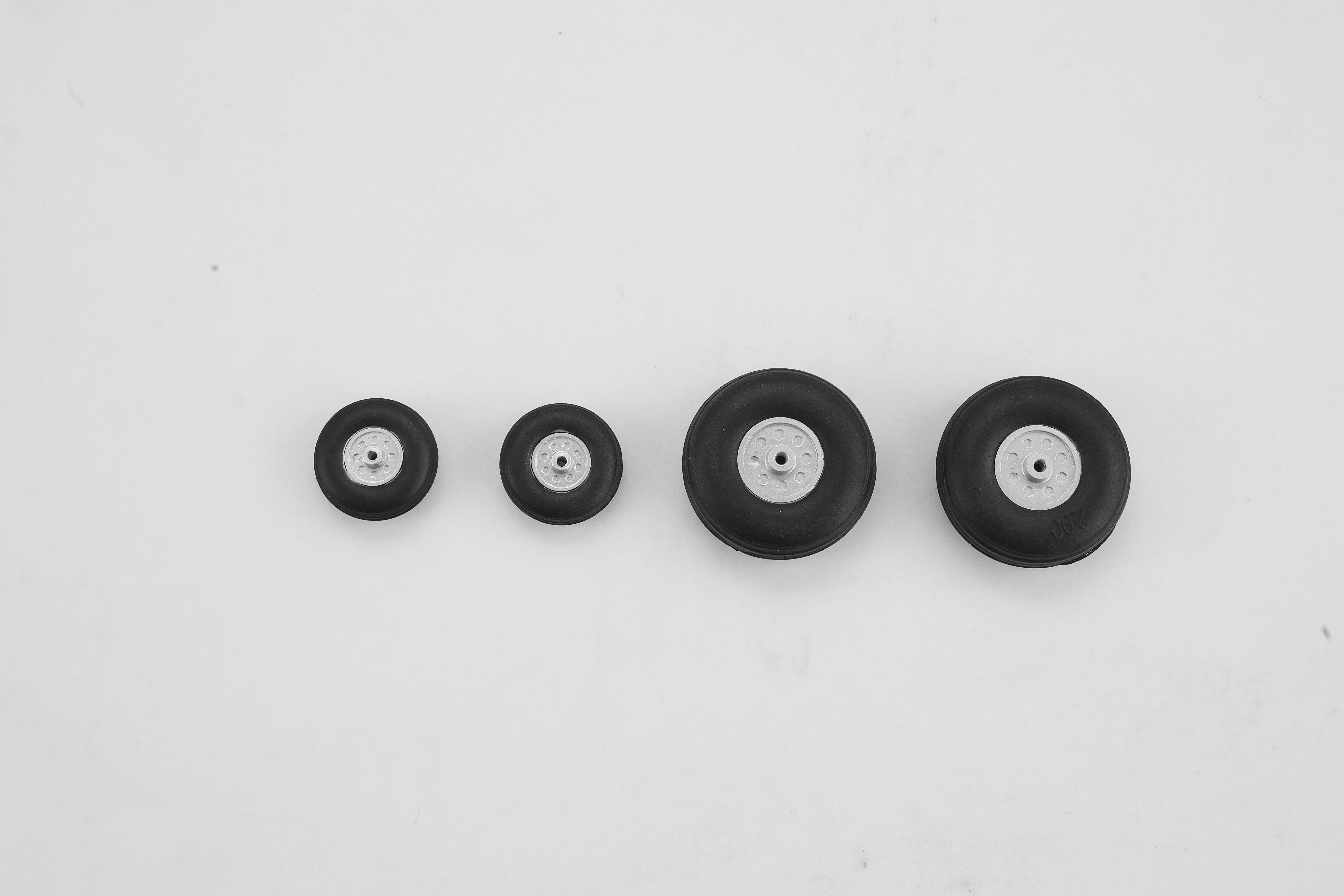Set of four wheels for 64mm Rafale EDF jet, varying sizes.