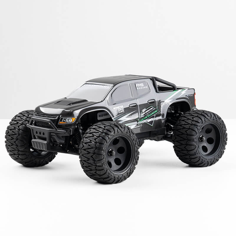FMS 1:24 FMT24 Chevrolet Colorado monster truck RTR in black, featuring rugged tires and FMS Racing graphics.