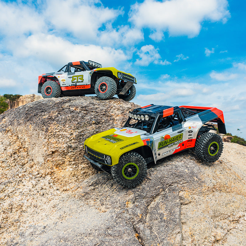 FMS 1:18 Ford Bronco RTR RC trucks on rocks, one with Fun-Haver Off-Road graphics.