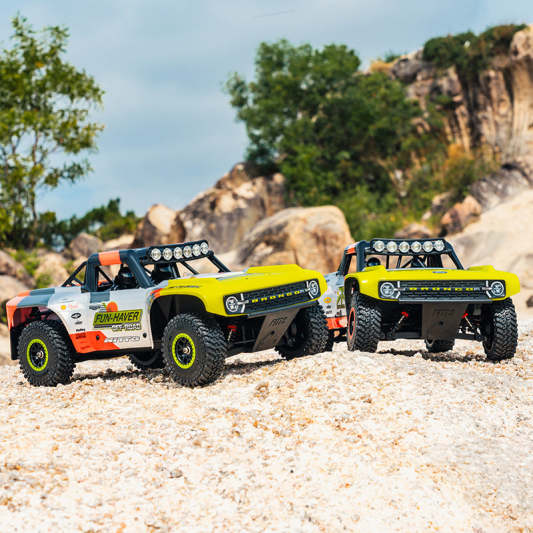 Two FMS 1:18 Ford Bronco RTR EB Fun-Haver off-road trucks.