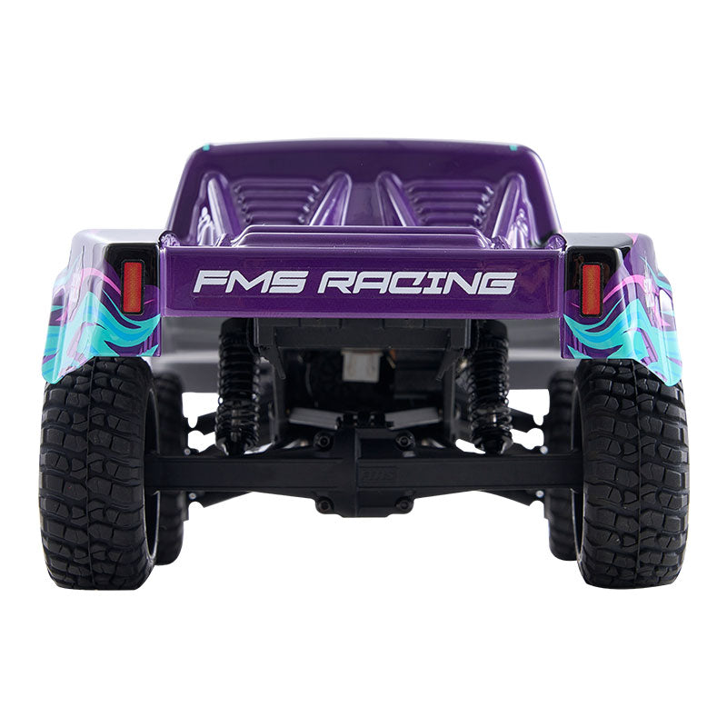 FMS 1:24 scale short course RC truck, purple body with FMS RACING text and teal-pink graphics, rear view.