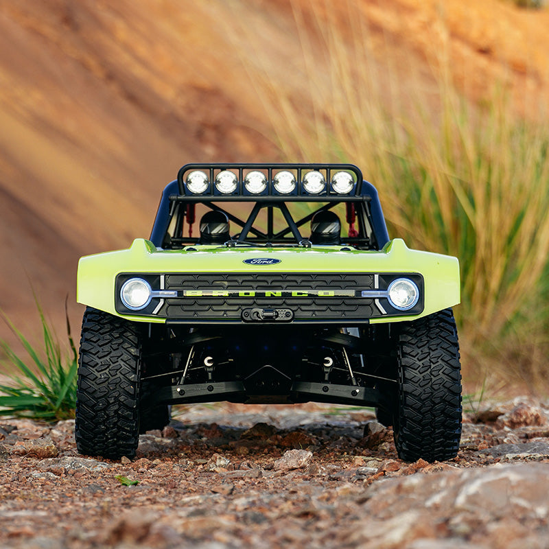 FMS 1:7 Ford Bronco RTR EB with bright green body, black roll cage with lights, and aggressive off-road tires.