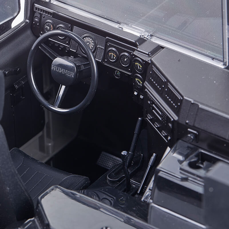 FMS 1:12 Hummer H1 Alpha RTR interior with detailed dashboard, steering wheel, and shifter.