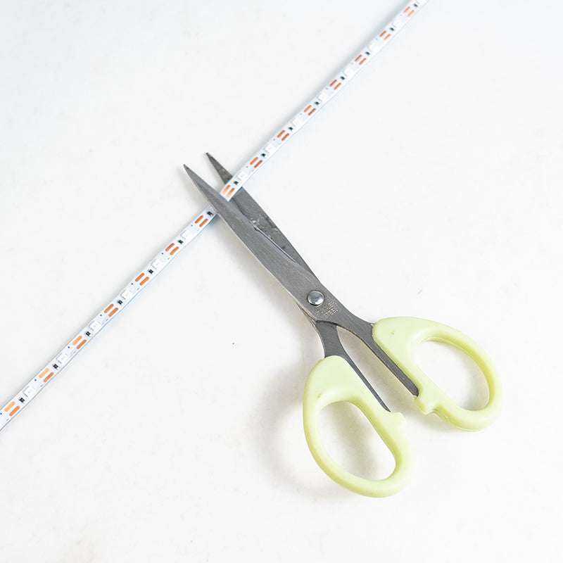 LED light strip being cut with scissors for aeromodelling projects