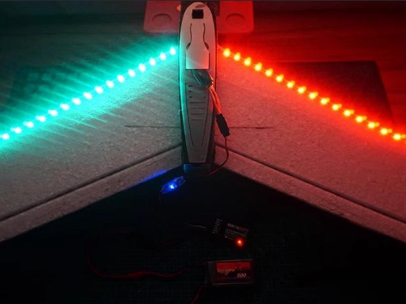 RGB LED light strip on aeromodelling model wing, glowing cyan and red for visibility