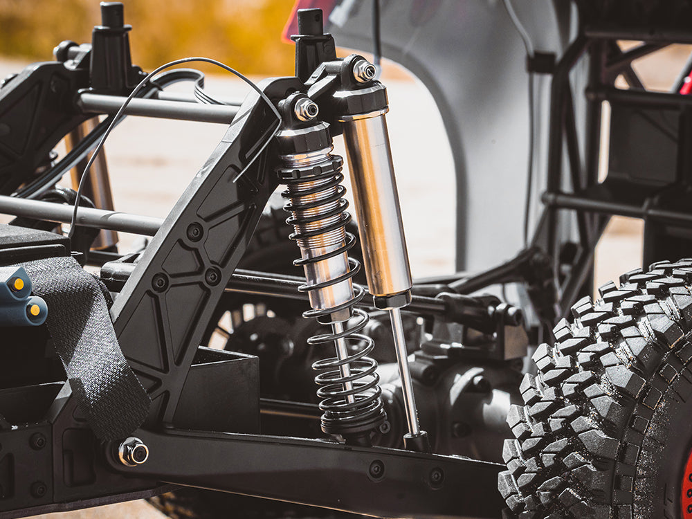 a piggyback coil-over shock absorber on the suspension of an off-road RC truck