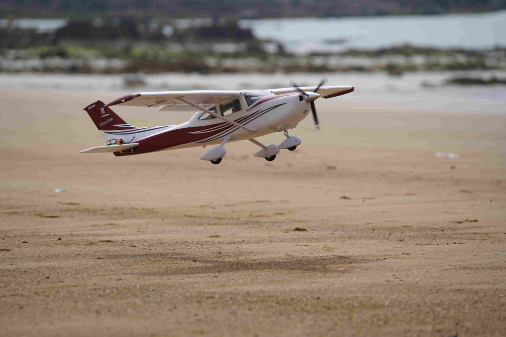 burgundy RC Cessna making low approach