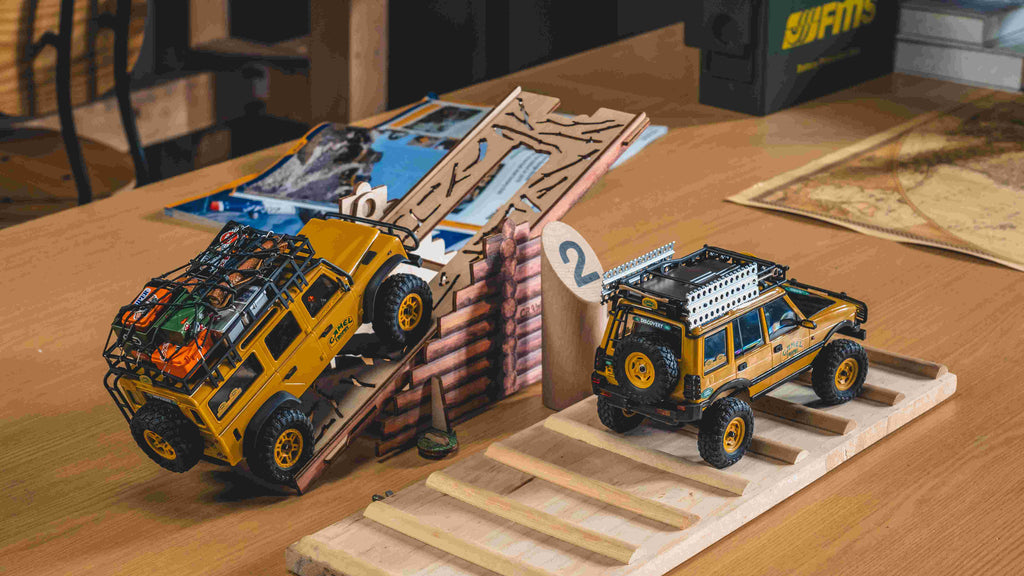 RC Camel Trophy Land Rovers on wooden ramp.