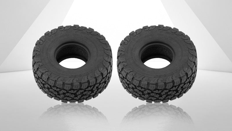 Two rugged off-road RC tires with deep tread patterns designed for high traction, displayed in a clean, minimalistic white studio setting.