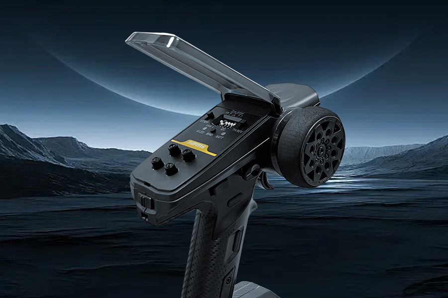 A Flysky pistol-grip RC transmitter with its protective settings cover flipped open