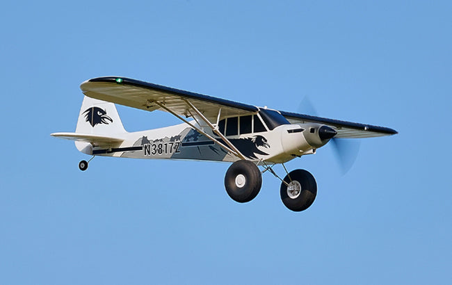 Light aircraft with N3817Z painted on its body, flying in a clear blue sky.