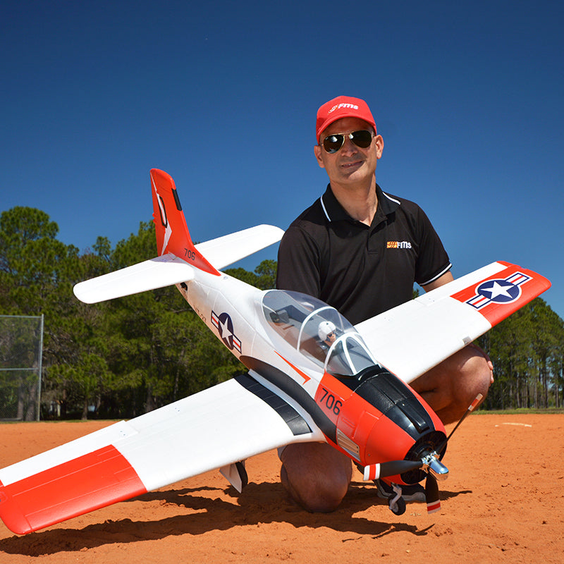 Man holding FMS 1400mm T-28D Trojan V4 Red PNP model aircraft
