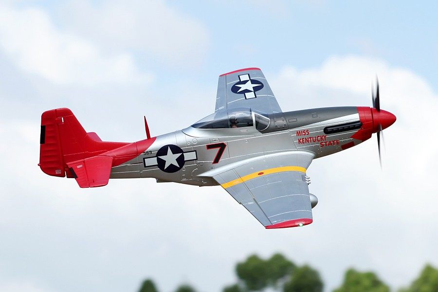 FMS 1700mm P-51D Red Tail PNP model airplane in flight. Silver body with red tail and nose.