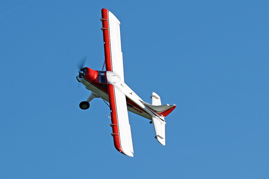 FMS 2000mm Beaver V2 seaplane PNP flying in blue sky, white and red fuselage, N56GM registration.