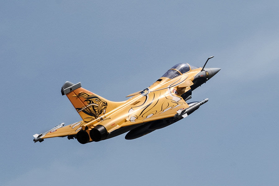 FMS 80mm Rafale jet with striking orange and black tiger graphics in flight