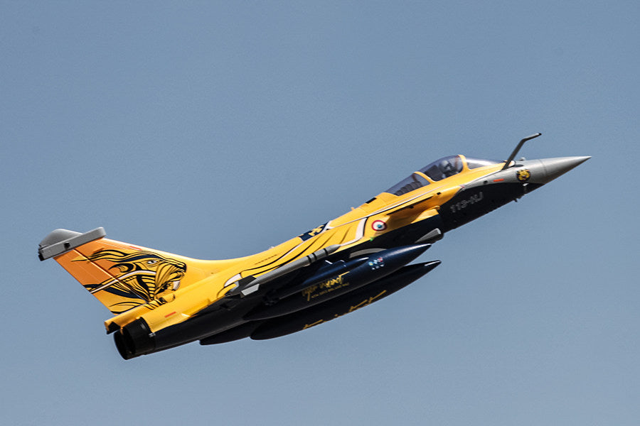 FMS 80mm Rafale EDF jet with yellow livery and tiger graphic, in flight.