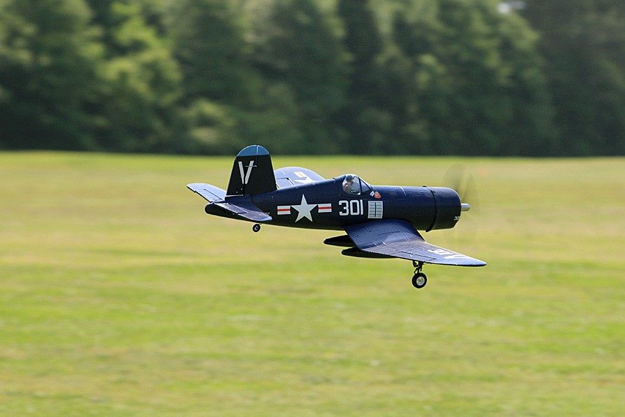 FMS 800mm F4U Corsair V2 RC airplane flying, dark blue with white insignia and '301'.