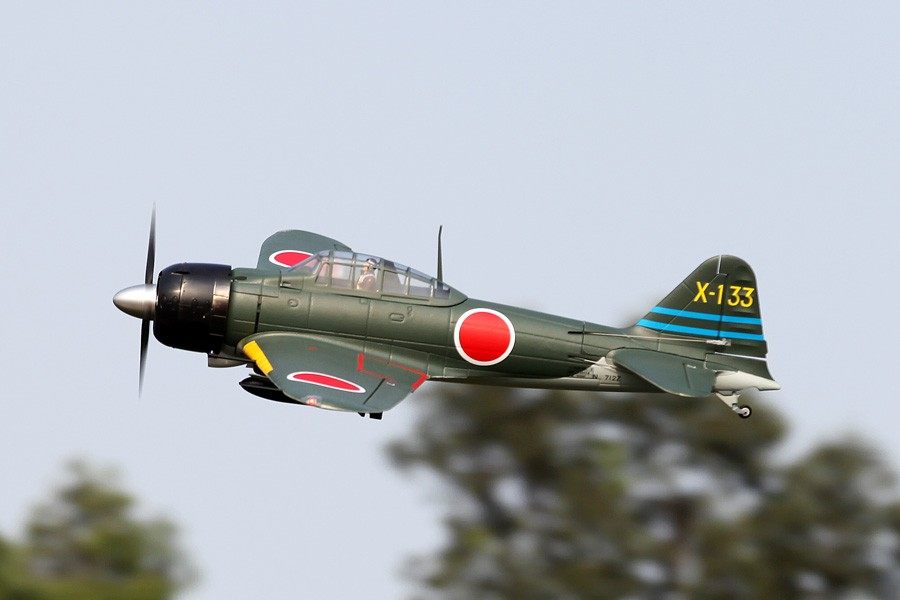 FMS 1400mm A6M3 Zero Green PNP model airplane in flight, featuring Japanese insignia and tail number X-133.