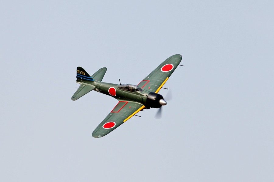 FMS 1400mm A6M3 Zero Green PNP RC airplane in flight with red insignia and tail number X-133.
