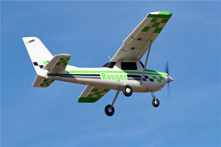 FMS 1800mm Ranger PNP model airplane in flight, white with green checkerboard accents