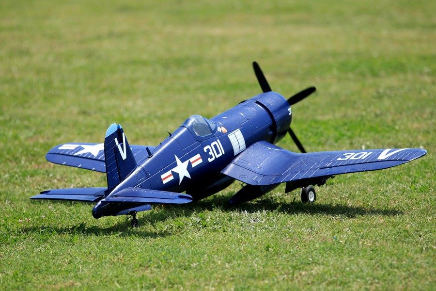 FMS 1400mm blue F4U Corsair RC plane on grass with markings '301' and star insignia.