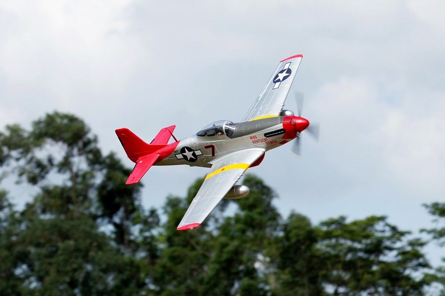 FMS 1700mm P-51D Red Tail PNP model airplane in flight. Silver with red tail and accents.