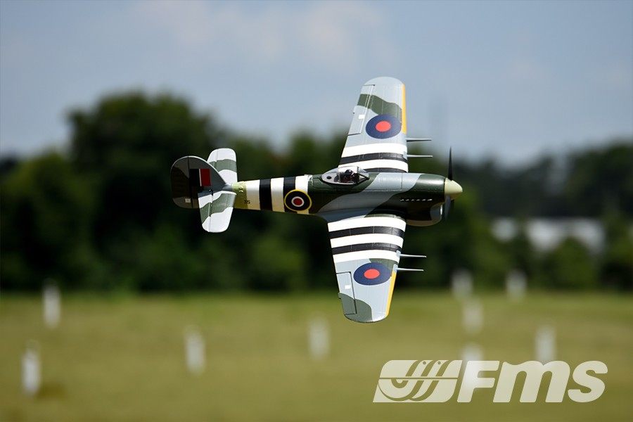FMS 1100mm Typhoon PNP model aircraft in flight, featuring camouflage paint and Royal Air Force markings.