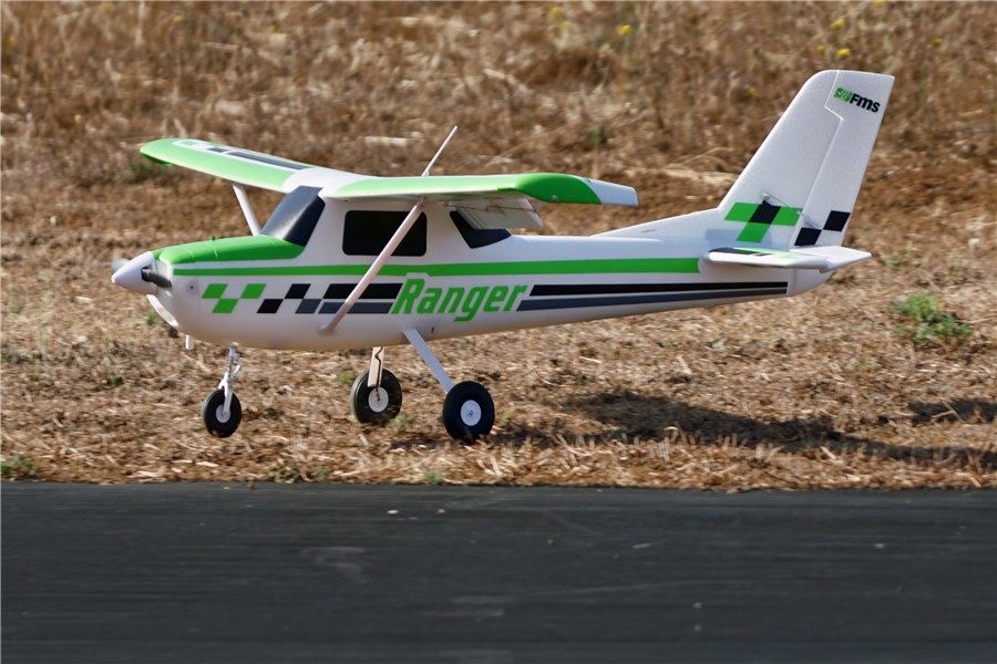 FMS 1800mm Ranger PNP RC airplane with green and white livery, taking off.