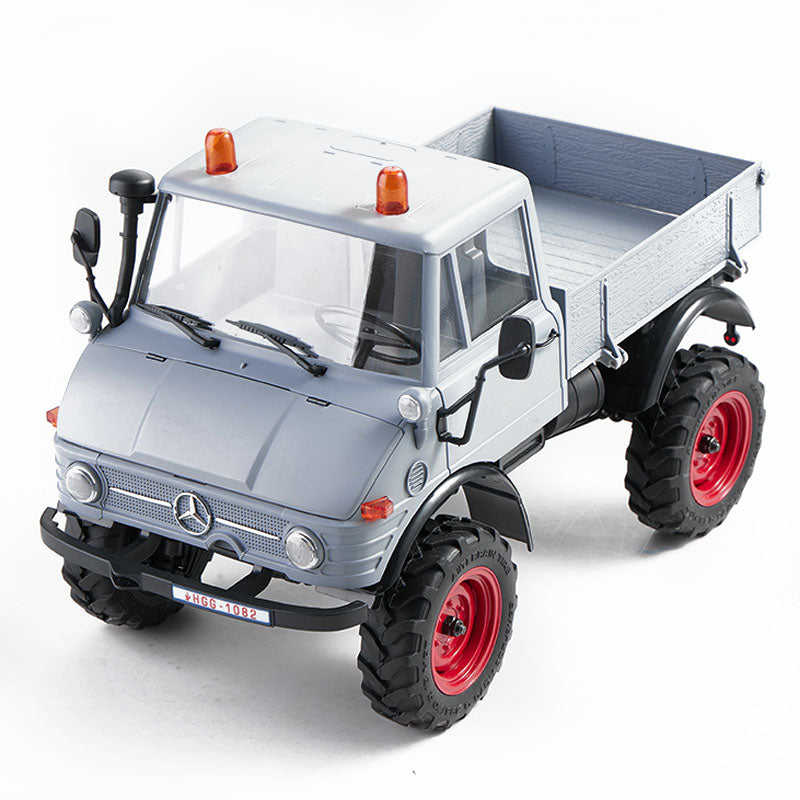FMS 1:24 FCX24 Mercedes-Benz Unimog 421 RTR remote control truck, gray body with red wheels and orange roof lights.